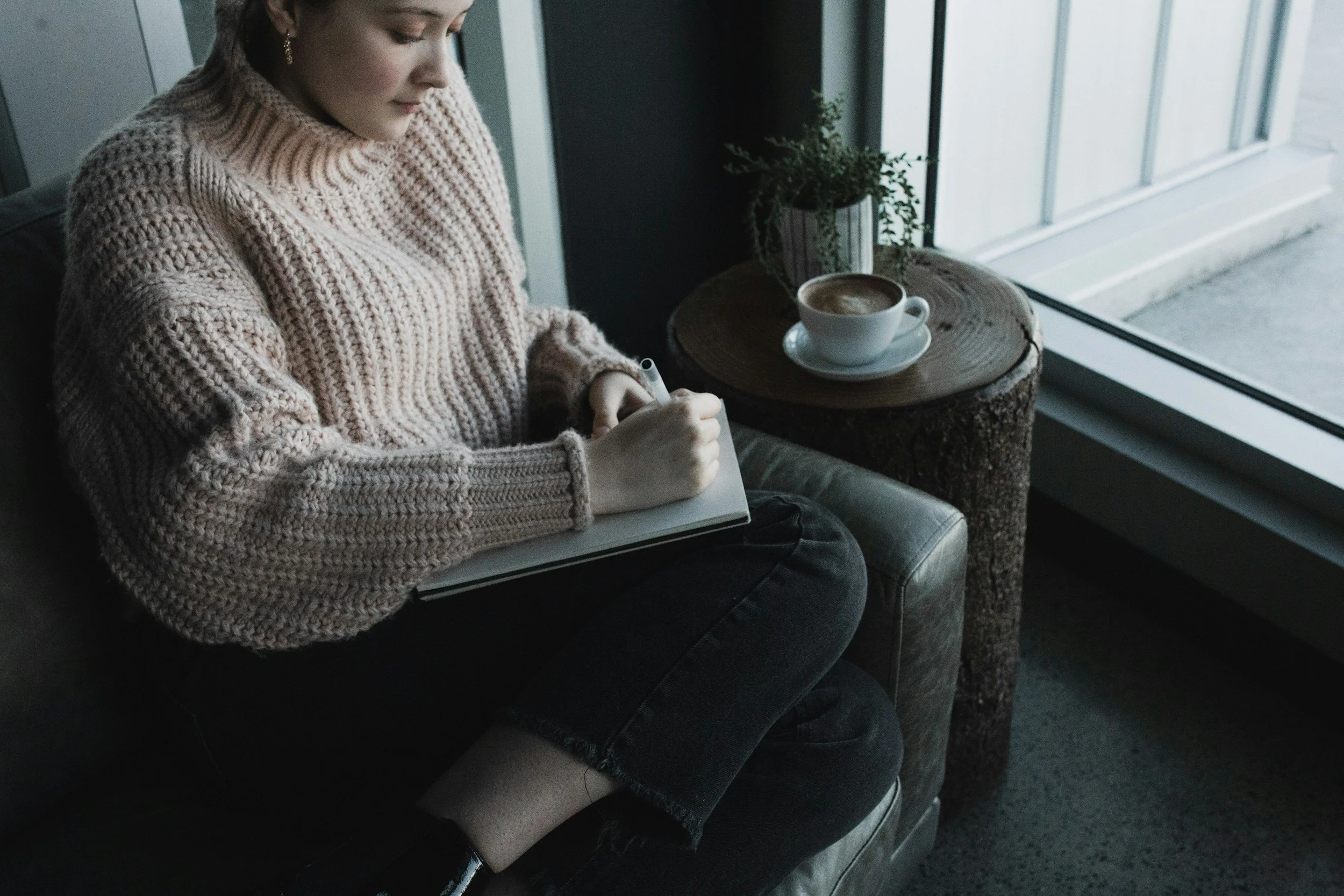 a woman journaling to reflect on her feelings about her difficult relationship
