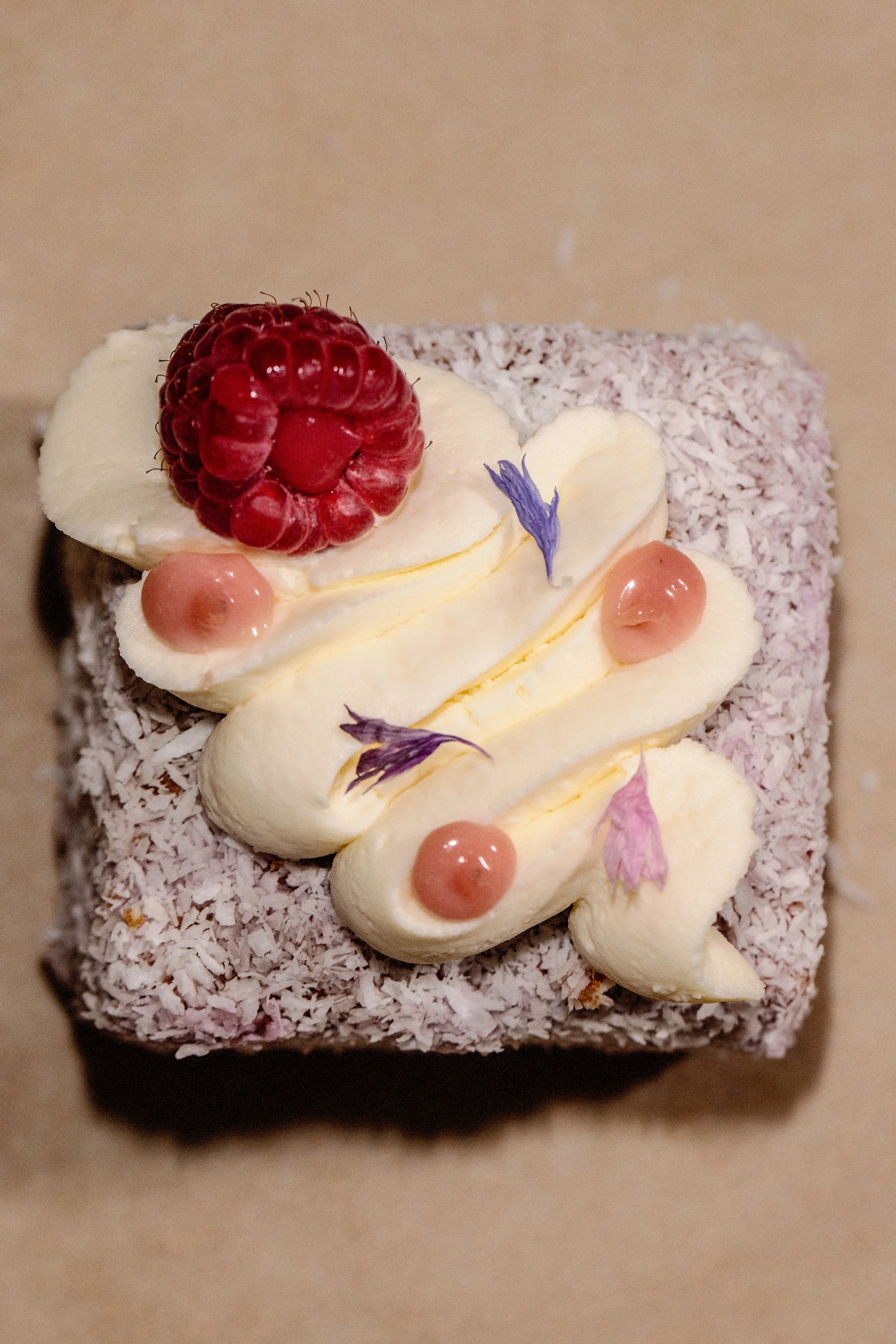 Our Version of a Lamington. Filled homemade Irish Raspberry Jam an Topped with whipped cream and Raspberry Curd (Weekends)