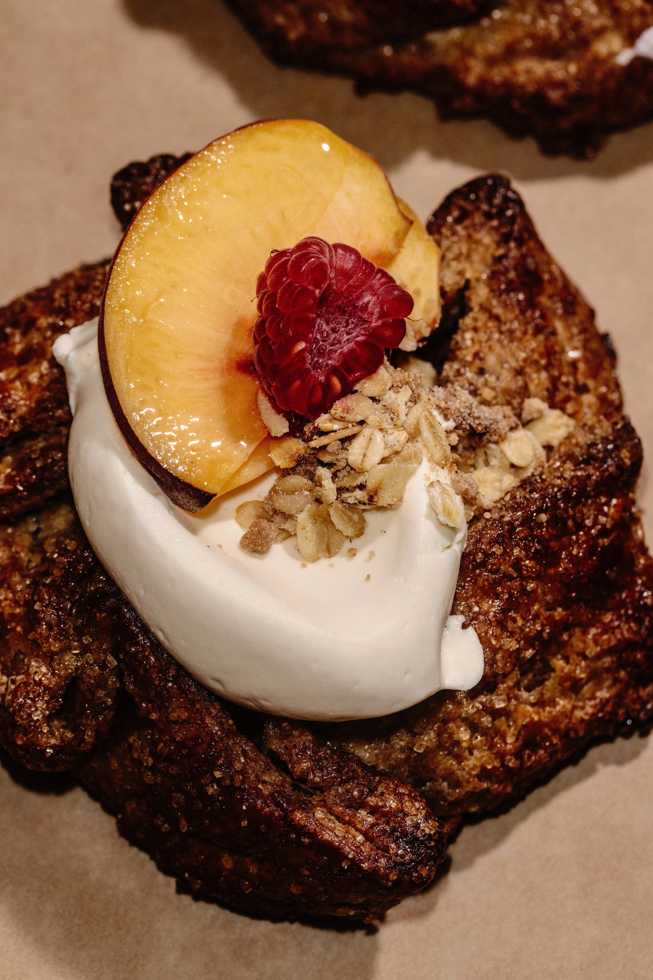 Manna Heritage Mills Pastry topped with Yellow Peach, Raspberry and whipped cream