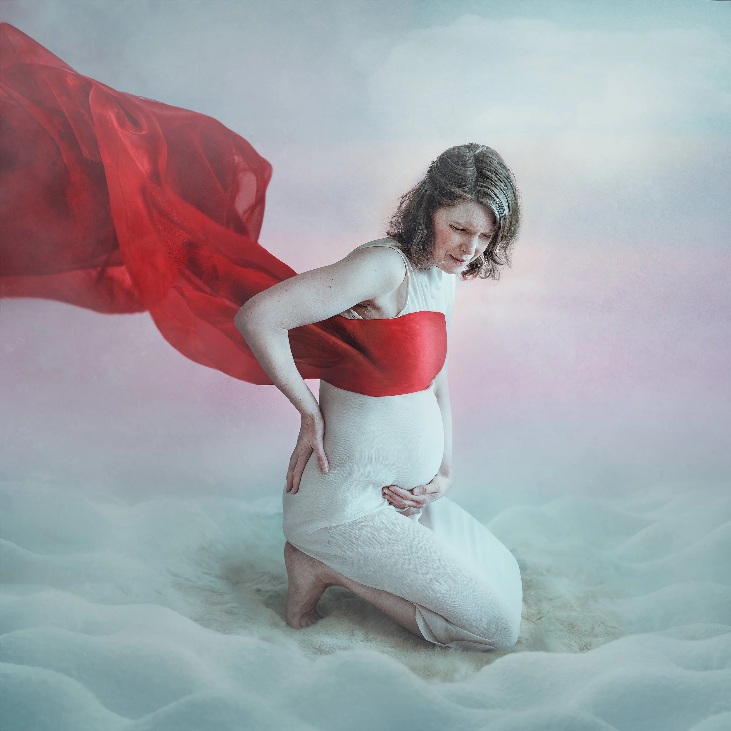 Arctic folk pop artist Mirja Palo, a pregnant woman in a beautiful dress, sitting on a soft white surface with red fabric flowing behind her, being in labour. photographed by Lisa-Love Bäckman