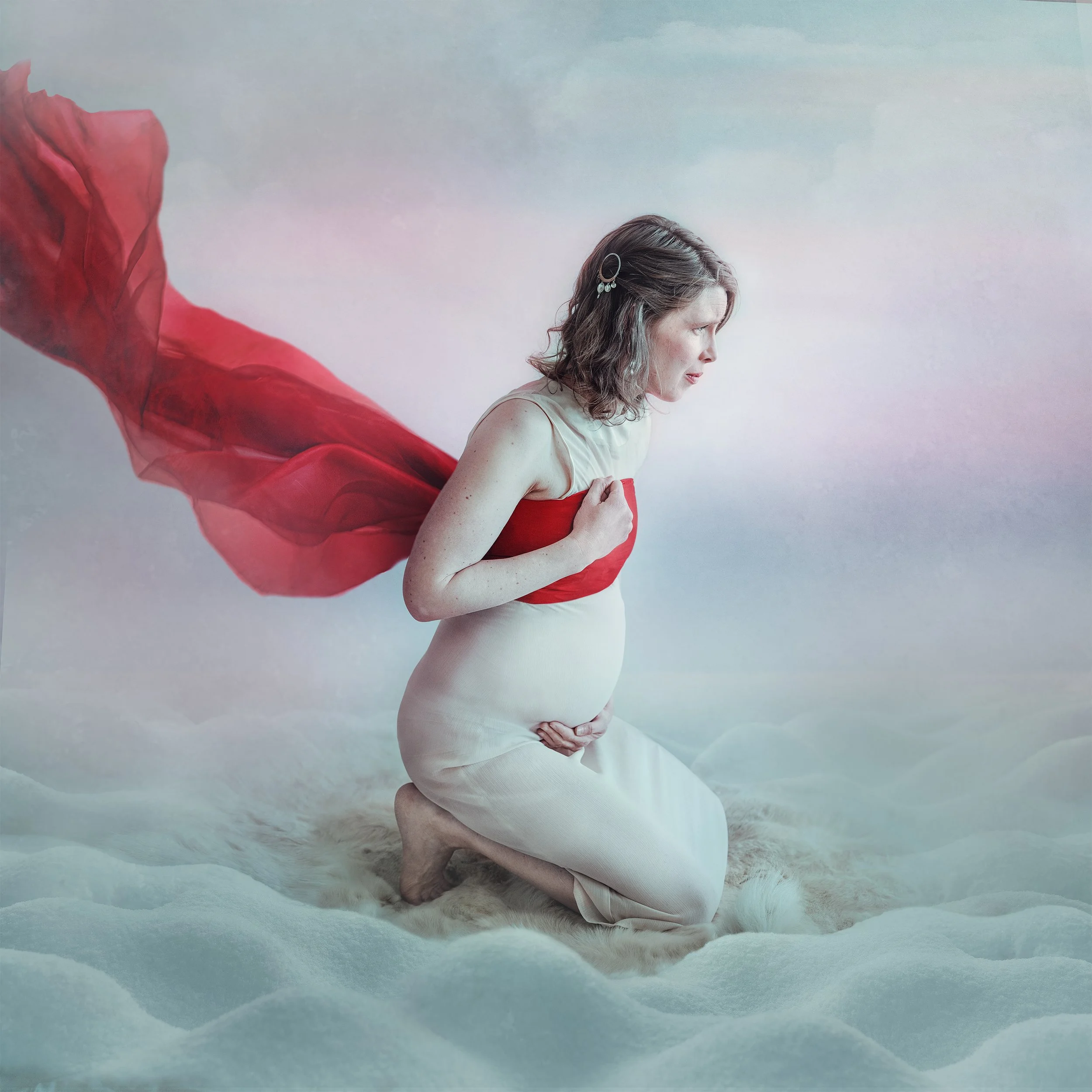 Arctic folk pop artist Mirja Palo, a pregnant woman in a beautiful dress, sitting on a soft white surface with red fabric flowing behind her. photographed by Lisa-Love Bäckman