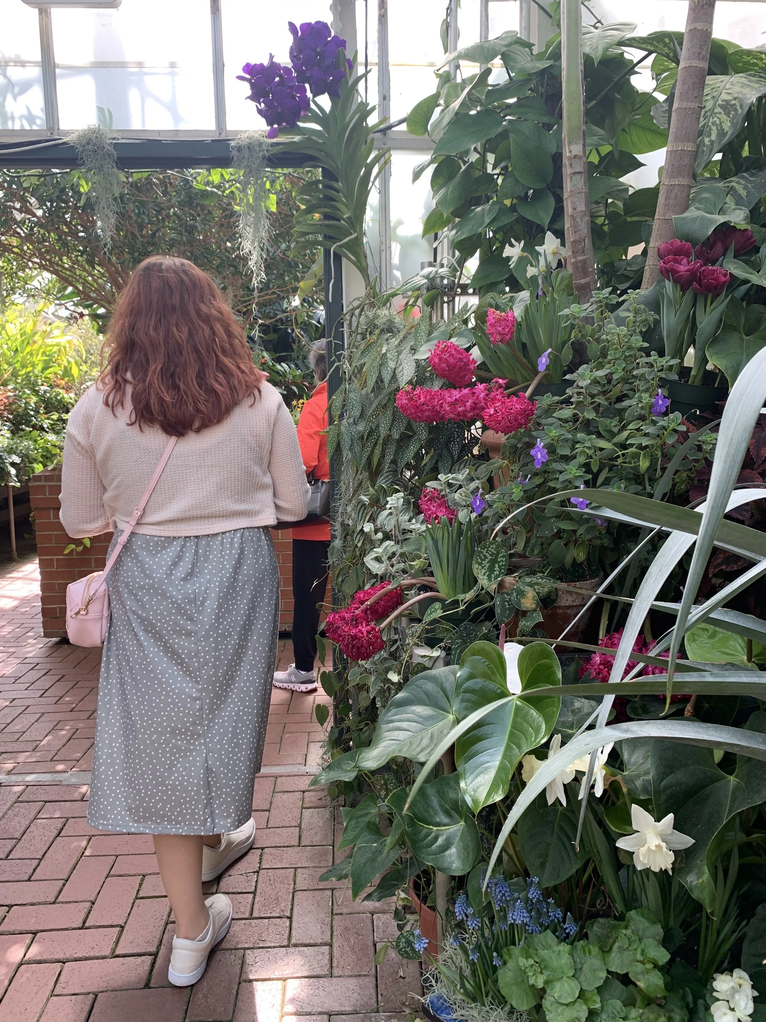 woman wearing a polkadot dress in a garden