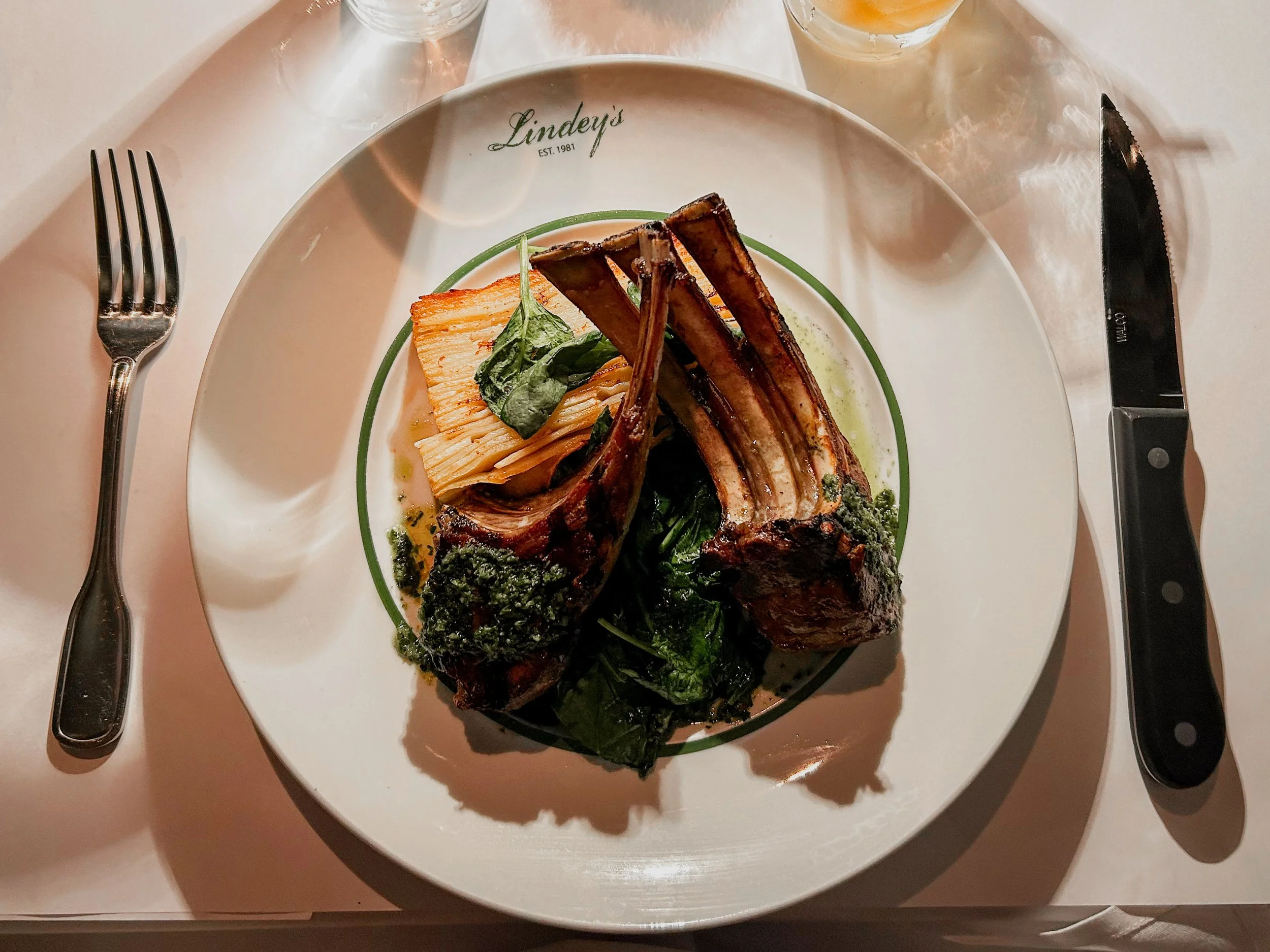 table lay out of a Lindey's plate with lamb and green sauce