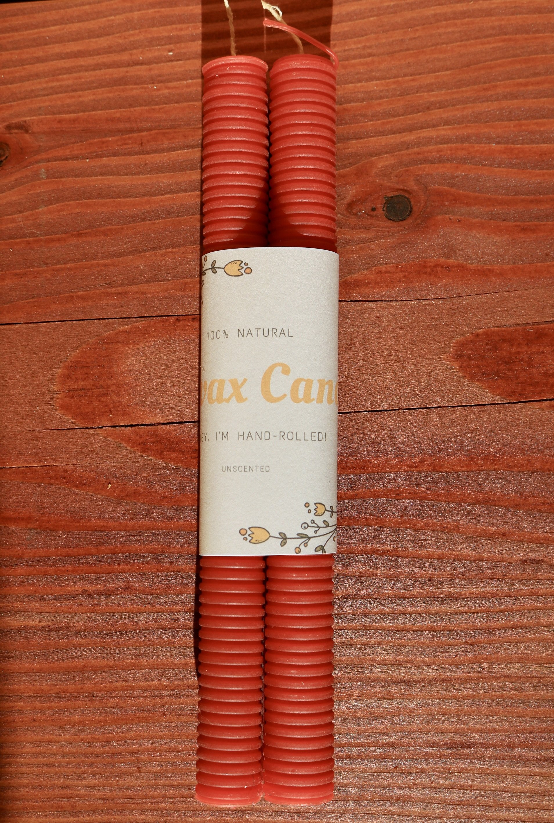 Terracotta red hand-rolled corrugated beeswax candle
