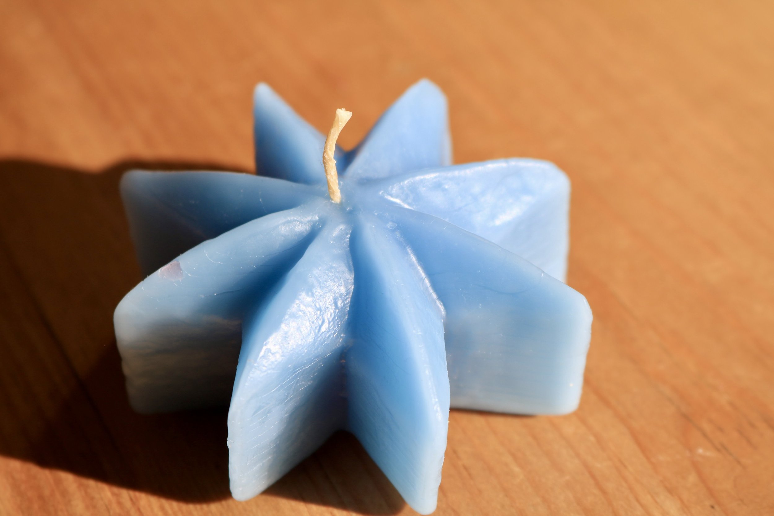 Glacier blue rustic star shaped beeswax candle.
