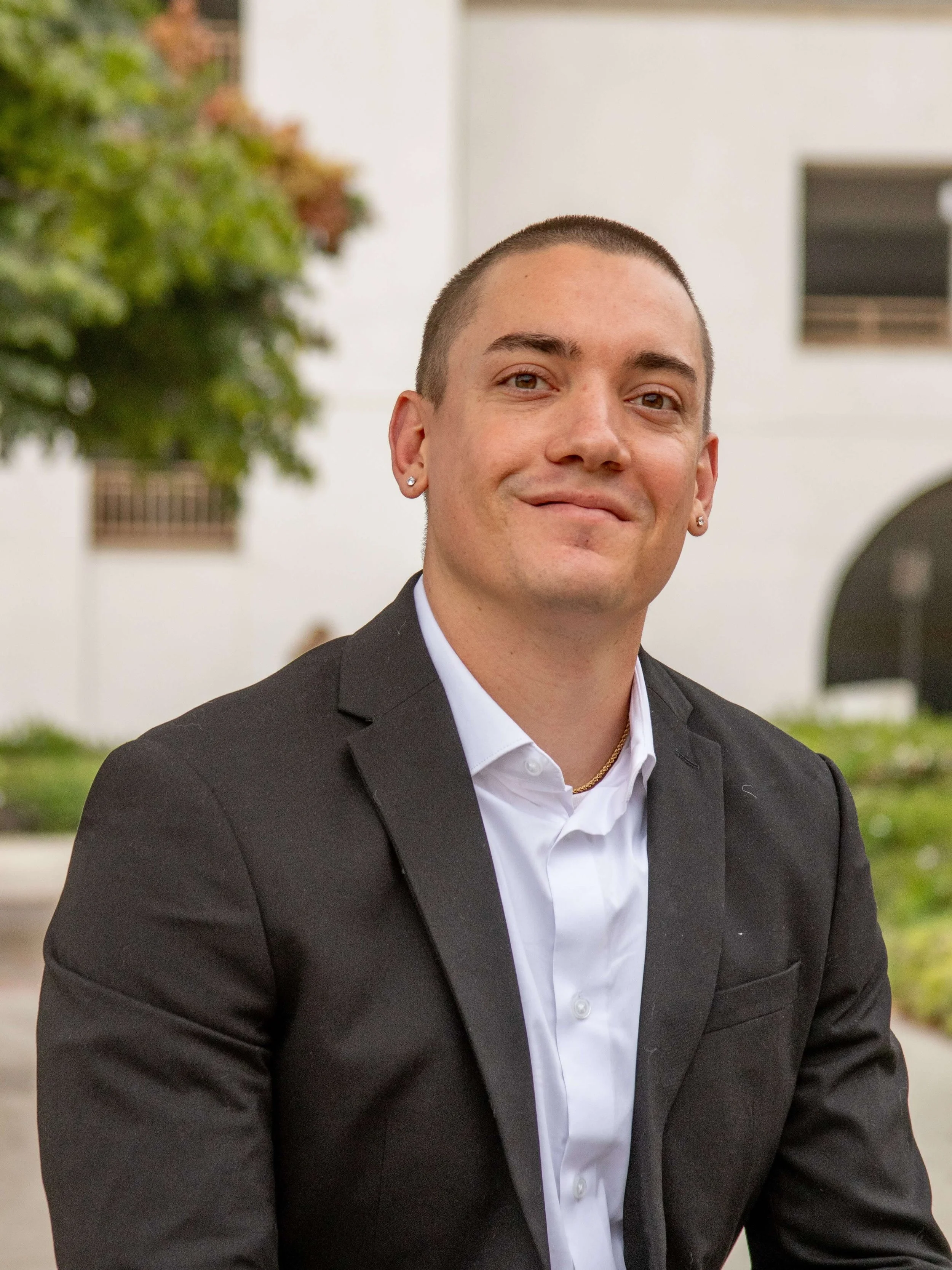 CJ Morgan, Santa Barbara tutor and civil engineer, specializing in History, Chemistry, Mathematics, and Physics, photographed outdoors on the UCSB campus wearing a black blazer and white shirt.