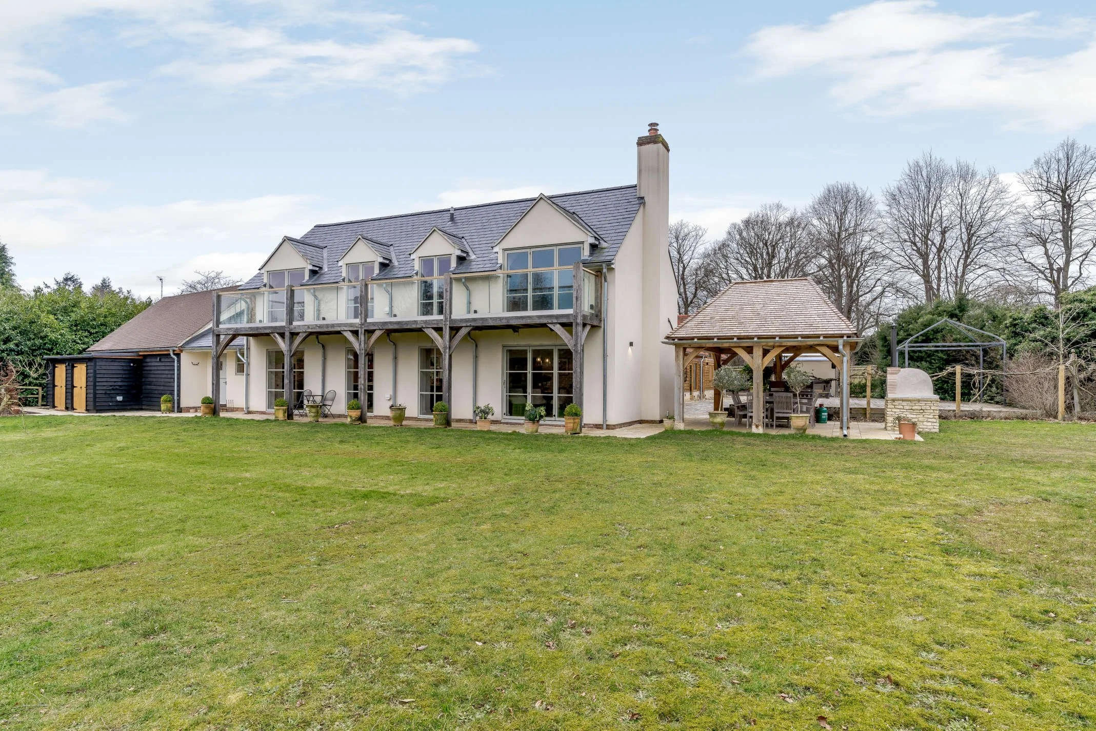 KD Design - Country house makeover, white render, Oak framed balcony with glass balustrading.jpg
