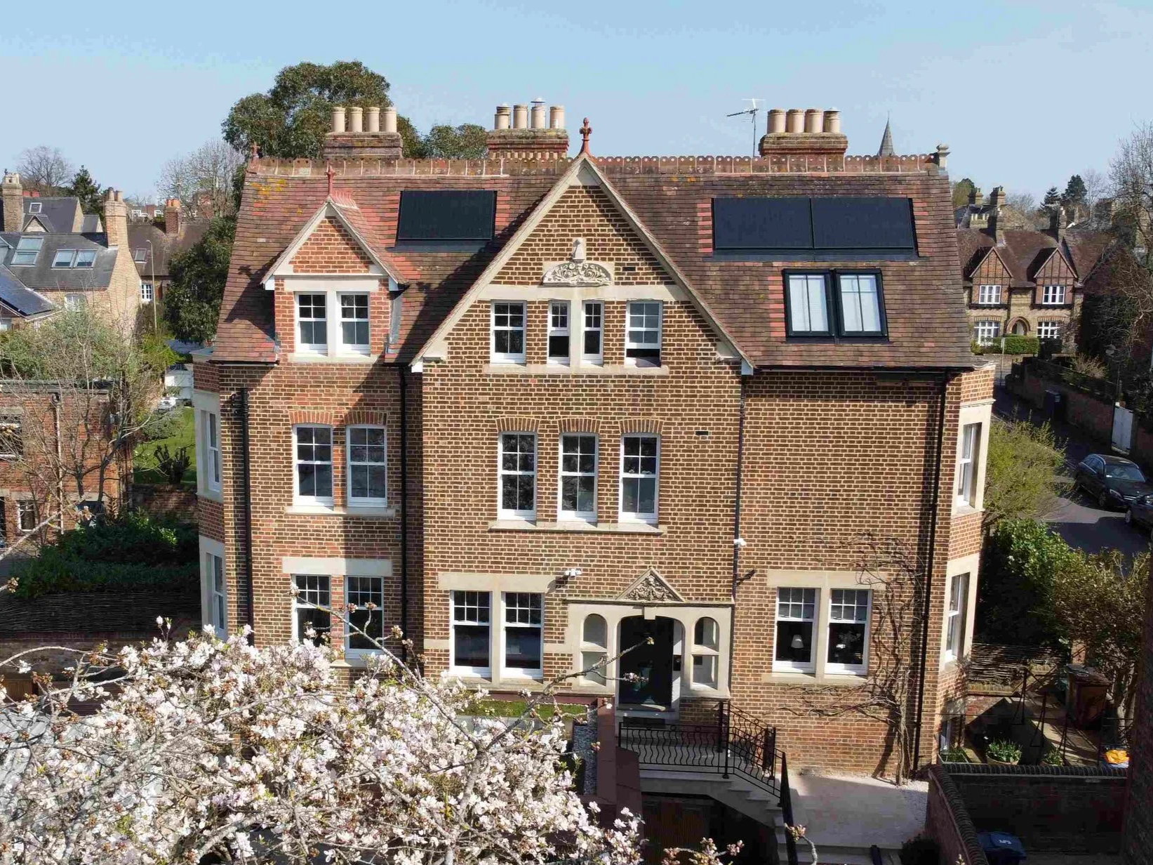 New Pitched roof dormer window with brick gable and stone window surrounds, integrated solar panels and conservation rooflights to Victorian town house in North Oxford, house originally designed by Architect Wilkinson and Moore