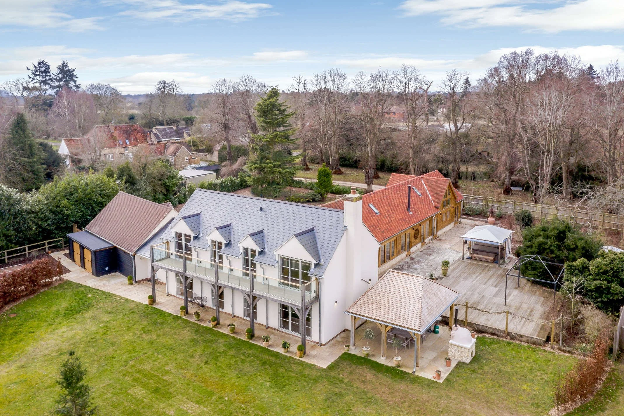 KD Design - Country house makeover, white render, Oak framed balcony with glass balustrading.jpg