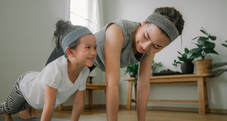 Parent and child exercising together at home.