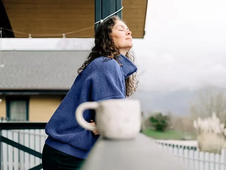 Adult taking a quiet break on a balcony.
