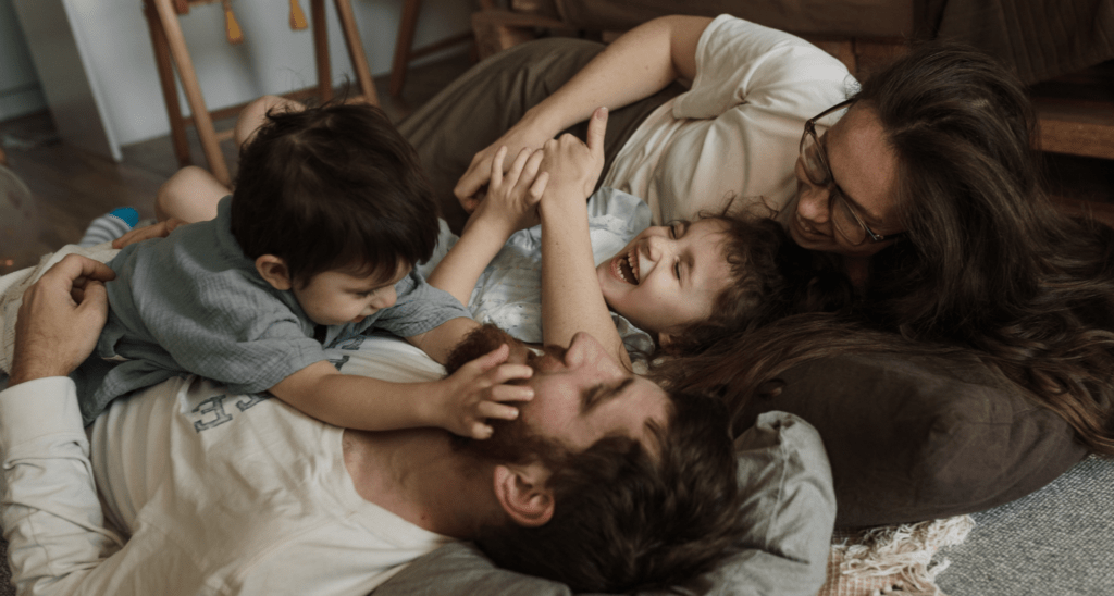 Family lying together and laughing.