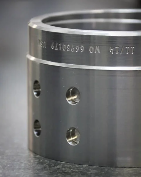 laser marked machined metal component with engraved serial numbers