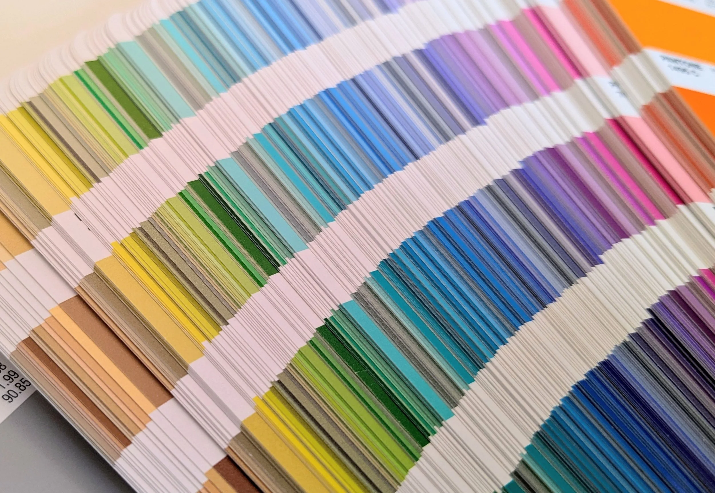 Full spectrum of colours in pantone fan spread open slightly