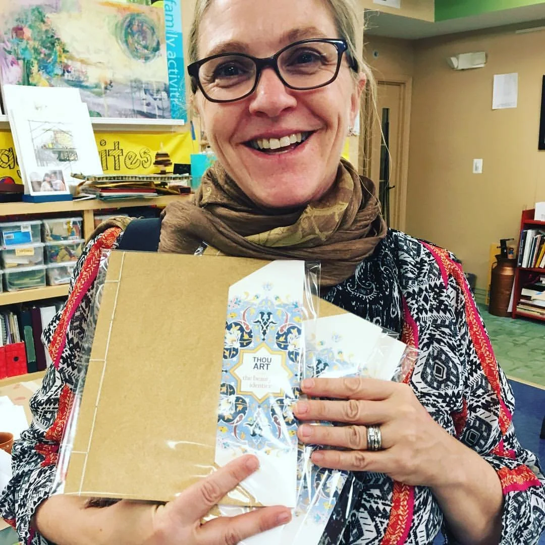 Carson with copies of her books, where you pay for one and get two—one to keep and one to give—because everybody needs to read these poems.