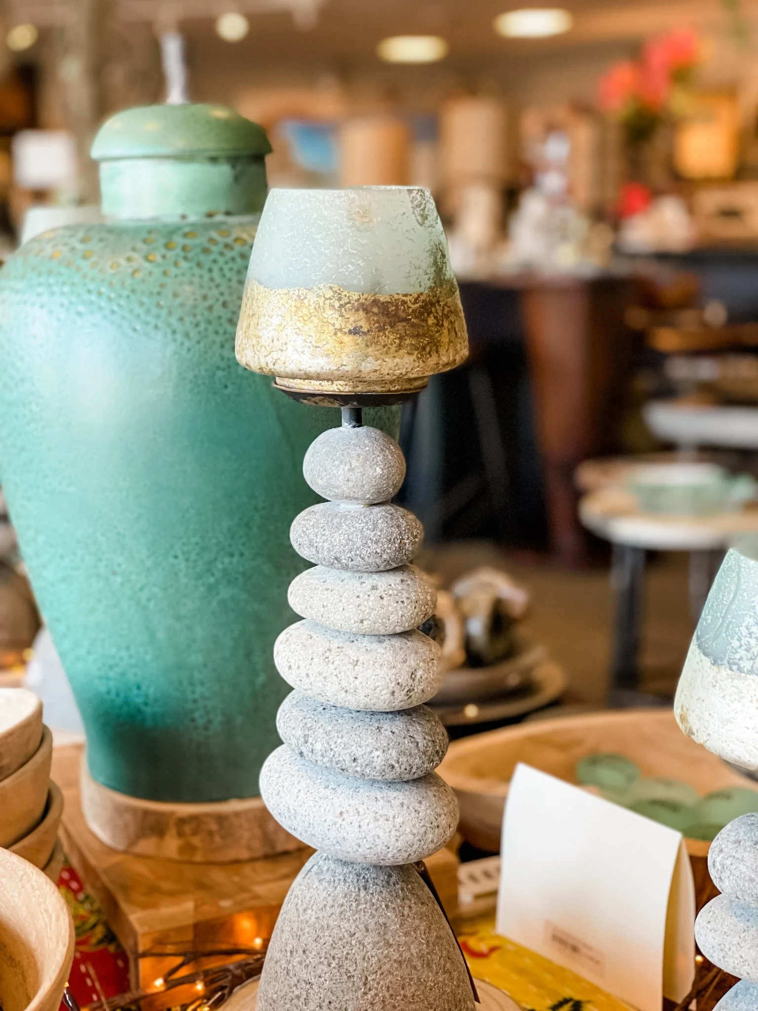 A stack of smooth, round gray stones arranged vertically on top of each other.