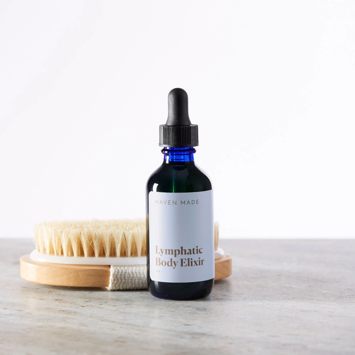 Lymphatic body oil bottle by Maven Made with vegan dry brush