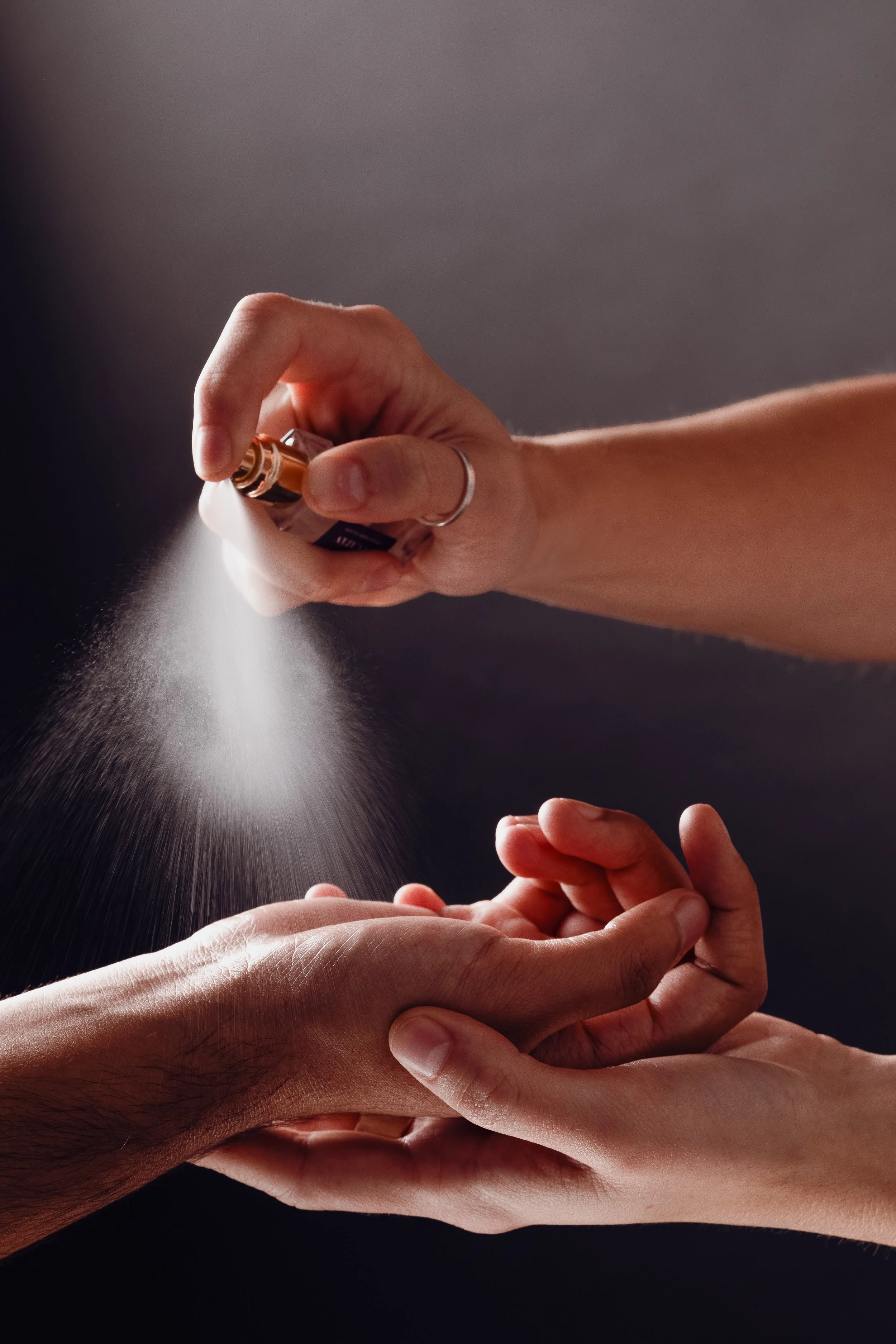 mini perfumes spraying on arm