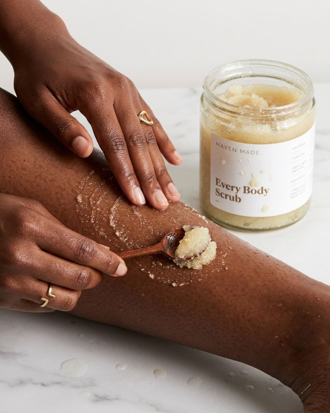 Every Body Scrub applied to leg with jar in background
