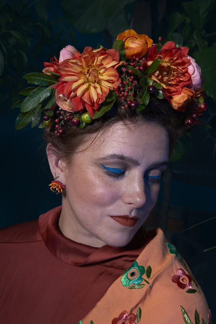 Portrait of Aby Algueseva in a bold flower crown, retouched by Glass Retouching.