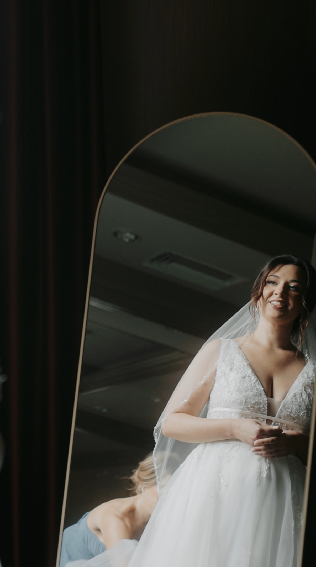 Bride looking at her reflection before her Pennsylvania wedding, captured by Zimmerman Videography