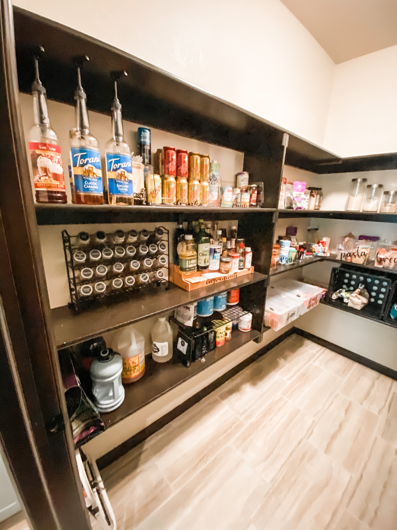 AFTERThere is a coffee bar right outside the pantry door in the kitchen. I placed the coffee syrups by the door so that the users can step right inside the pantry and pump their flavors.