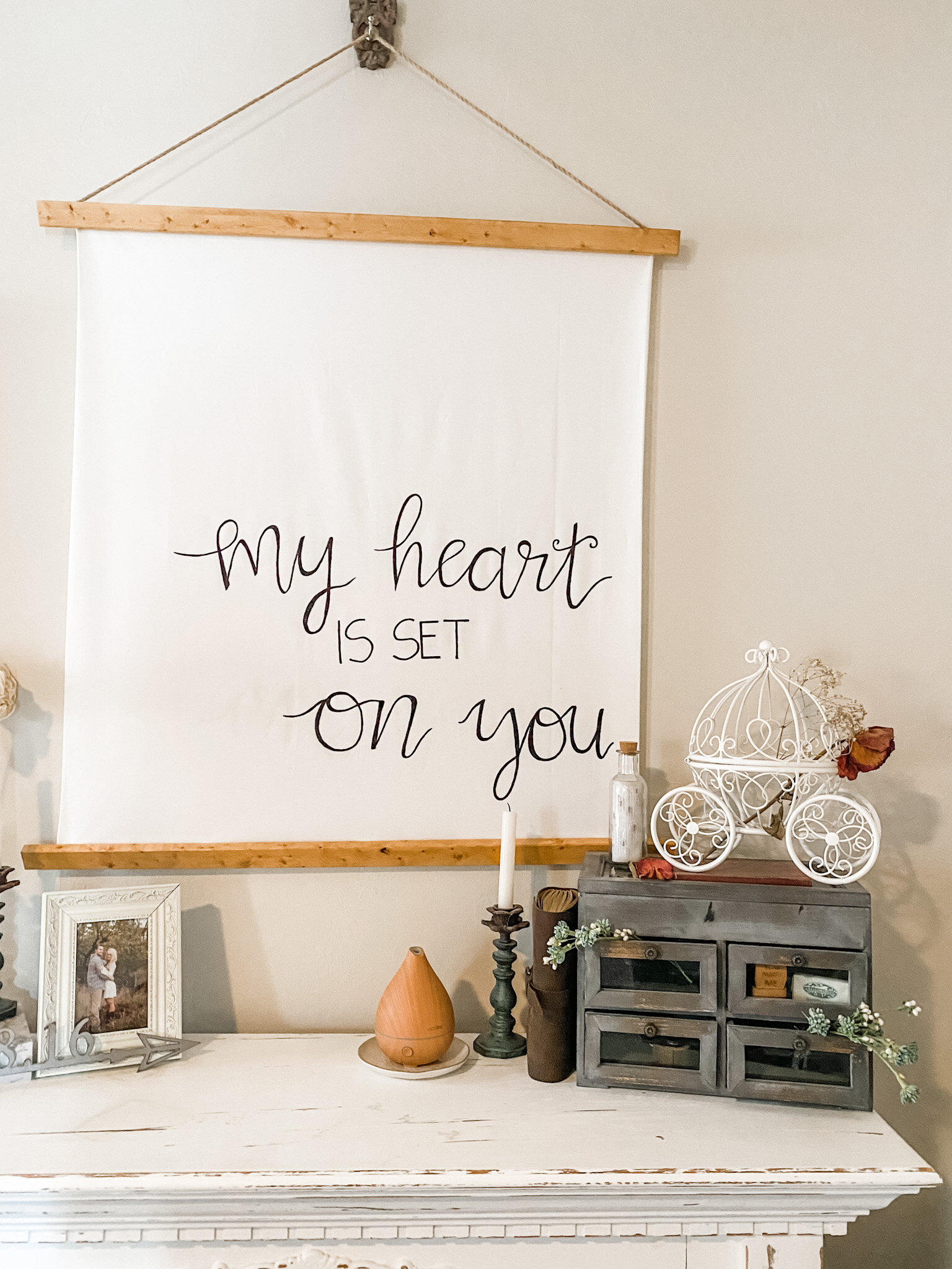 This corner of our bedroom houses all of our wedding and engagement memorabilia. We have several knick knacks related to our history together and I wanted to create a place to showcase them. The glass drawers hold several pieces from our engagement.…