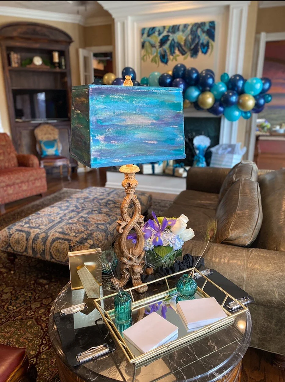 I painted white lamp shades to match the peacock theme!