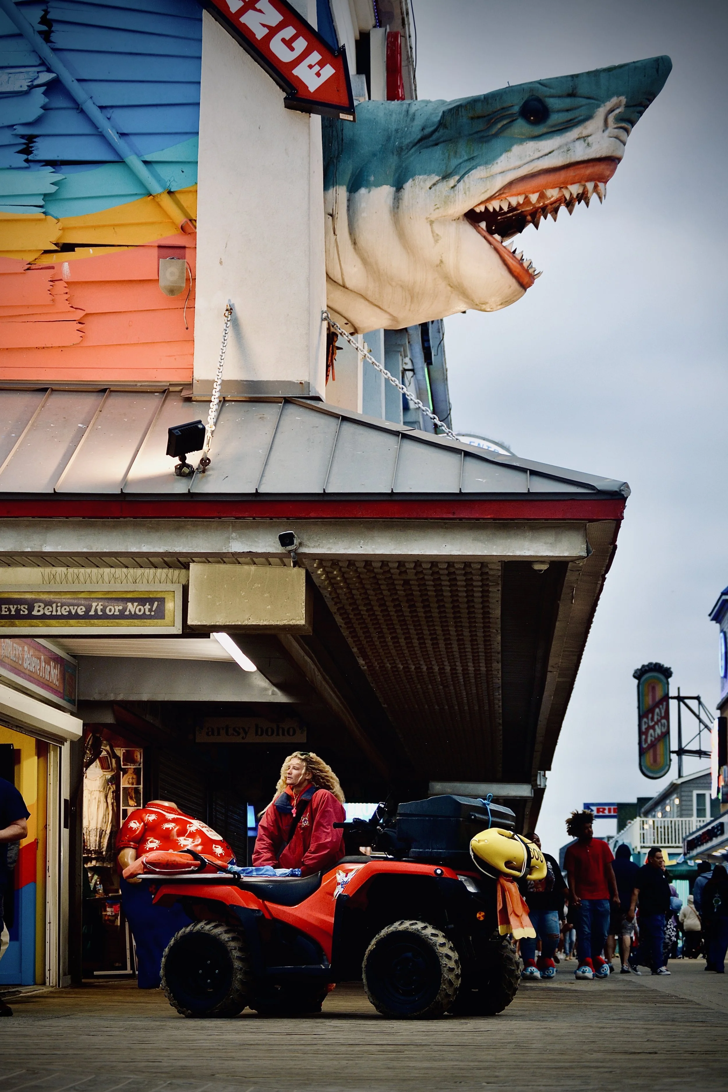 Ocean City Boardwalk Category (Grand Prize Winner): "The Life Guard and The Shark" by Tom Powell III. Photo Description: OCBP lifeguard under the Ripley’s Believe it or Not Shark during Hurricane Erin, August 20th, 2025. Judge's Notes:  I found the c