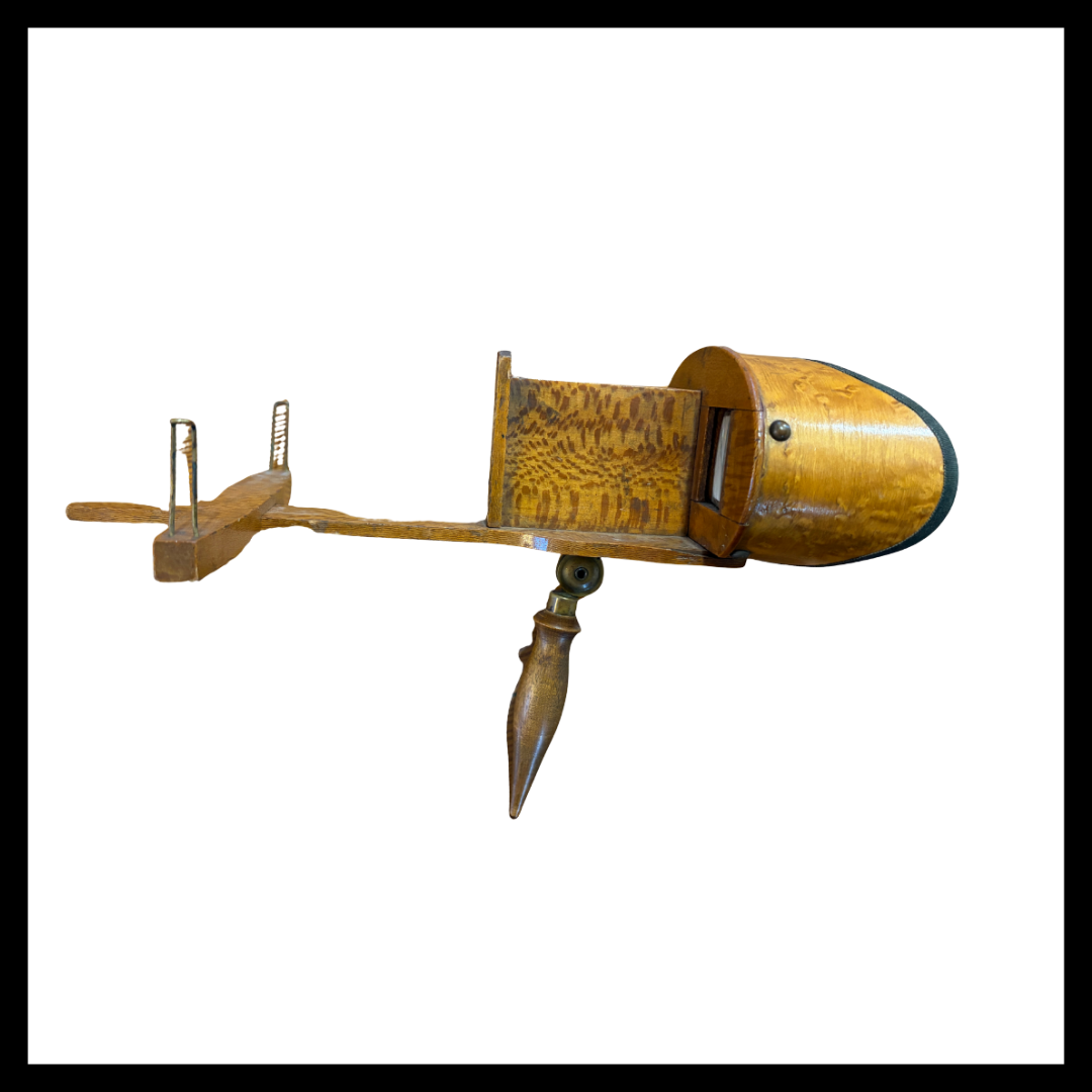 This artifact is a wooden Holmes-style stereoscope, dated July 24, 1888, was a popular form of home entertainment in the late 19th century. Designed to view paired photographs called stereographs or stereoviews, the device creates the illusion of dep