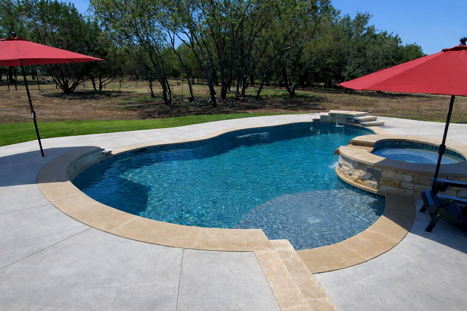 A backyard view of a swimming pool with steps leading down to it, surrounded by a stone deck. There is a stone-built house with a covered patio area with seating in the background. A large sign indicates the pool is rated five stars.