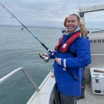 student scientist fishing on the sea