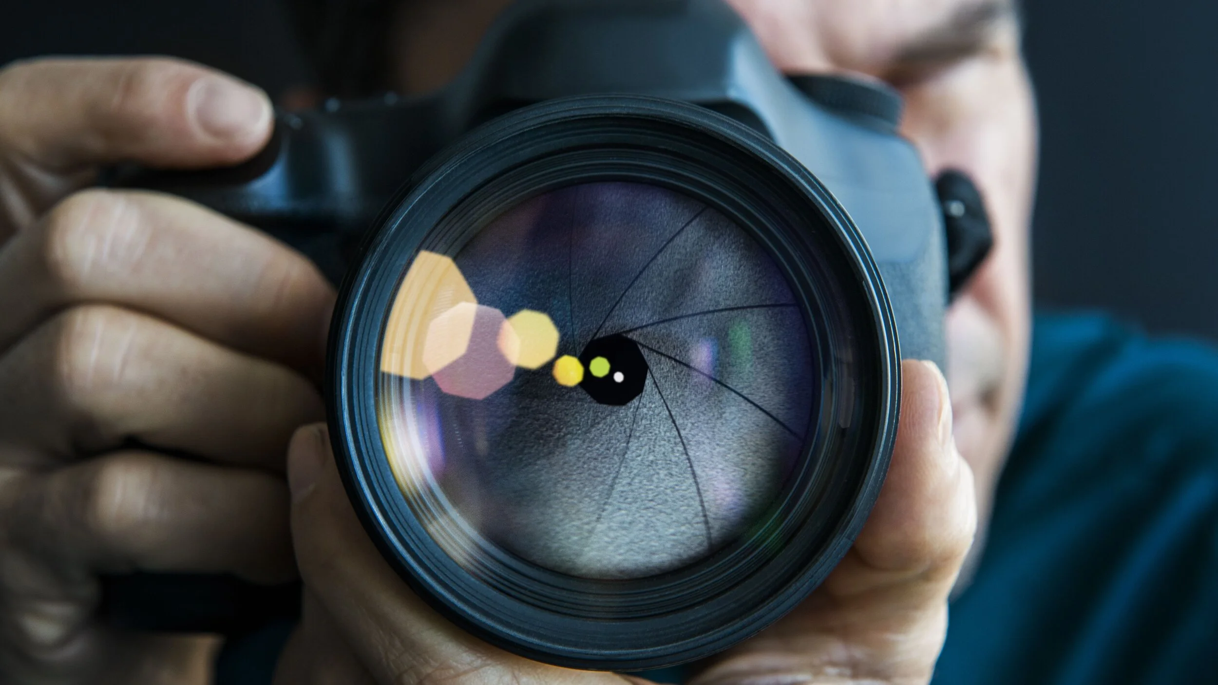 man-holding-camer--close-up-of-lens-665240977-5a3a0543e258f80036667f37.jpg
