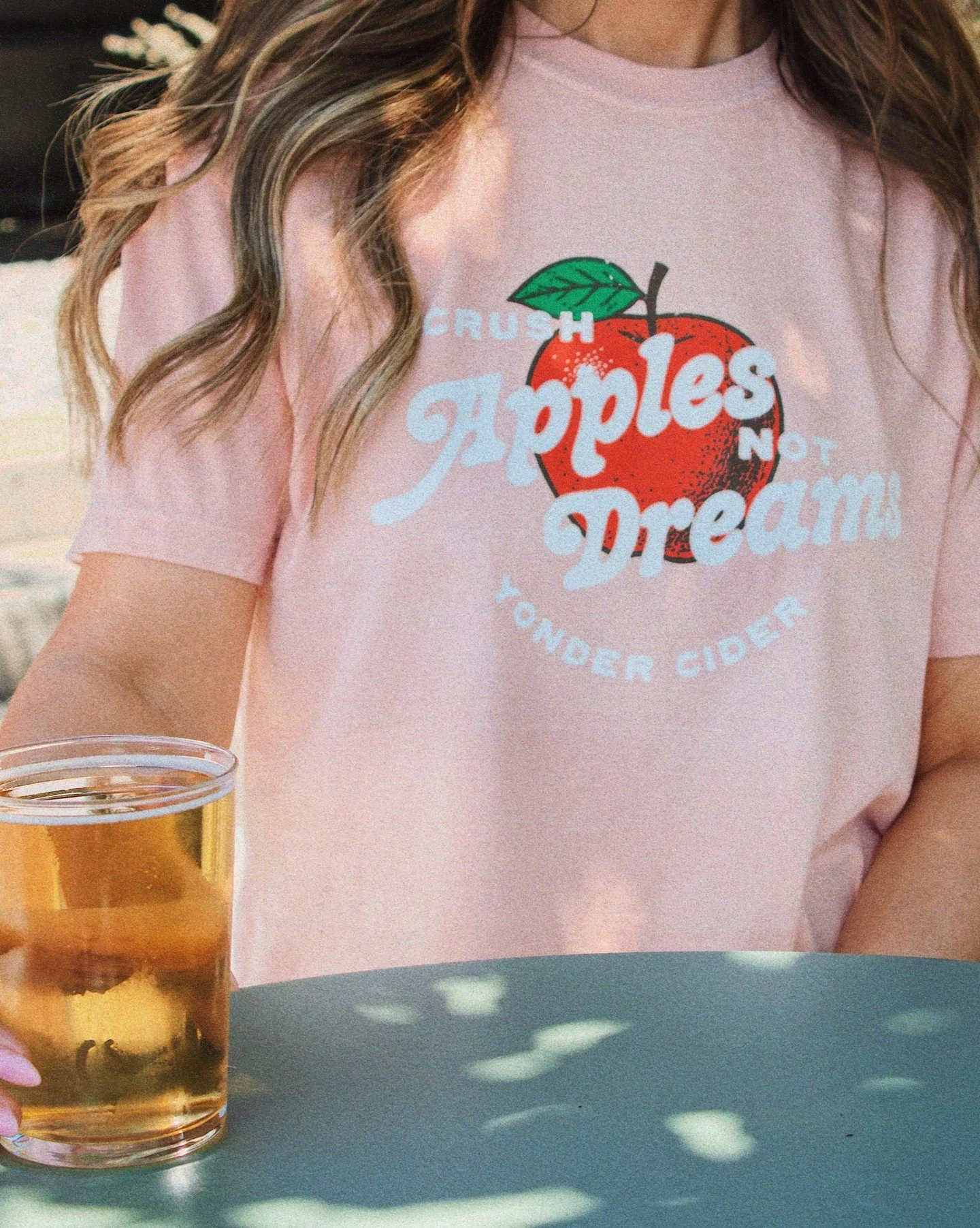 CRUSH APPLES, NOT DREAMS. 🍎⁠
⁠
A little appreciation post for the &ldquo;Crush Apples Not Dreams&rdquo; crop top. Peach-colored, easy to wear, and very Yonder.⁠
⁠
Throw it on with your favorite jeans, shorts, or whatever you&rsquo;re wearing to the 