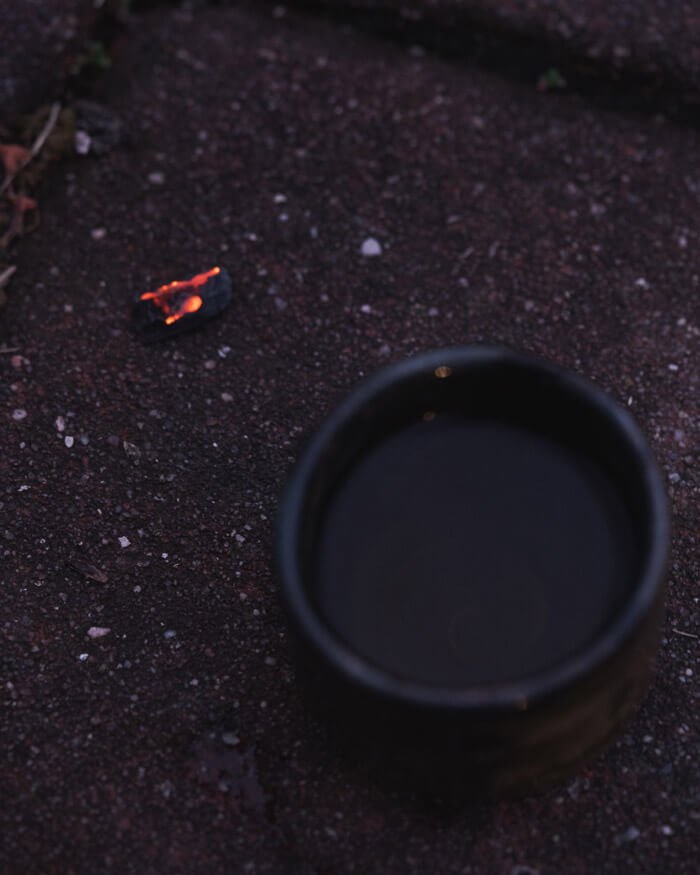 Cup of Tea on Ground with an Ember