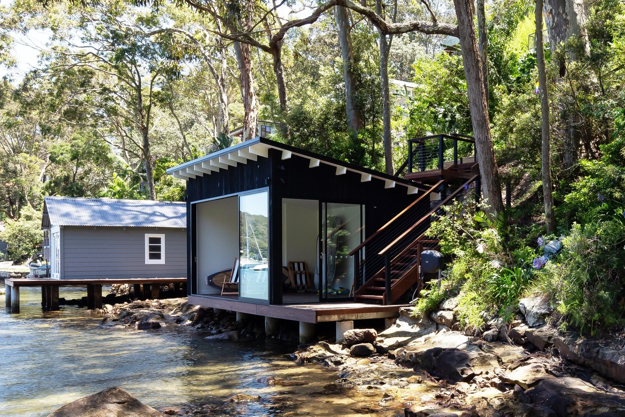 Tucked into the shoreline, this little waterside build is all about simple lines, smart design and enjoying the view &mdash; preferably barefoot, coffee in hand, watching the tide roll past.