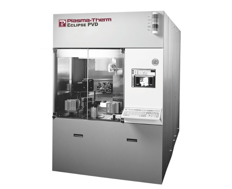 The Plasma-Therm Eclipse PVD Platform. It is a frontal photo of the system. PVD equipment is enclosed in a glass cabinet on the left side, and there is a monitor/keyboard combination on the right side