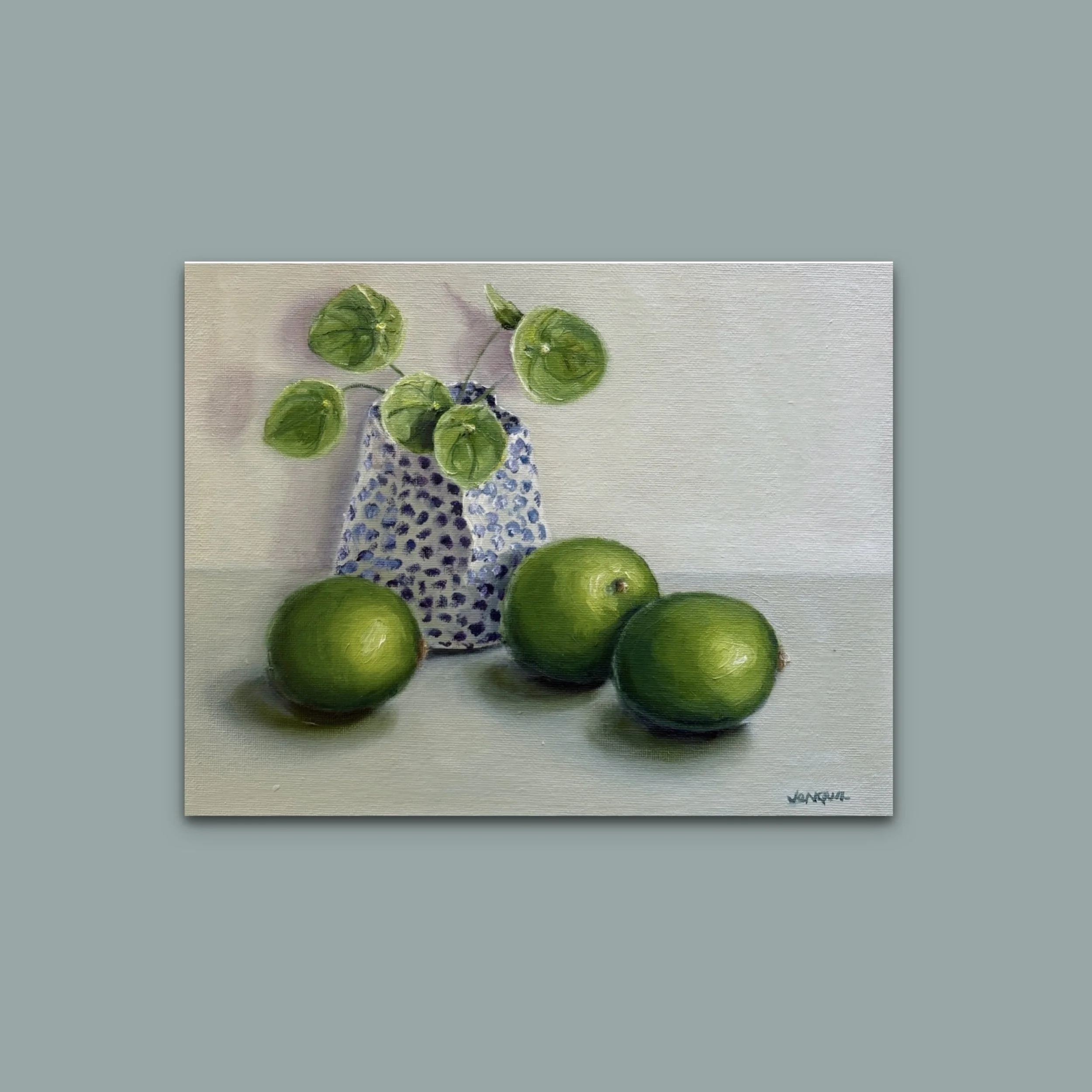 Small framed oil painting of green fruit still life with soft natural light and muted tones