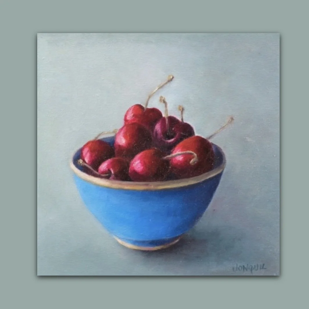 Colourful still life oil painting of cherries in a blue bowl by British artist Jonquil Williamson