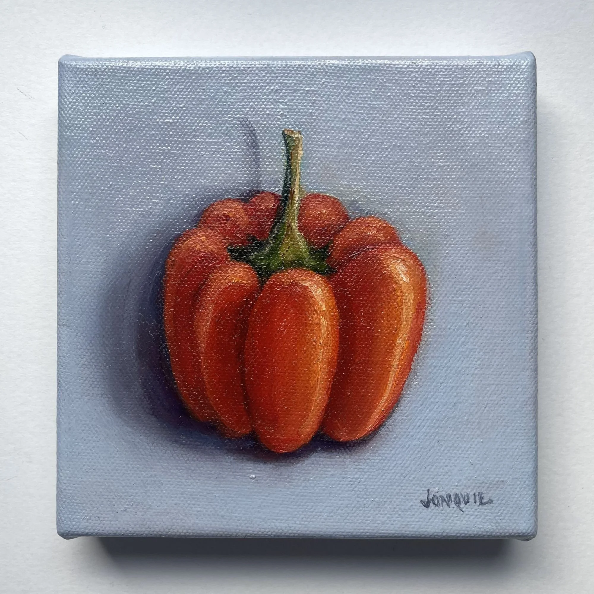 Mini oil painting of a red bell pepper on a soft grey background.