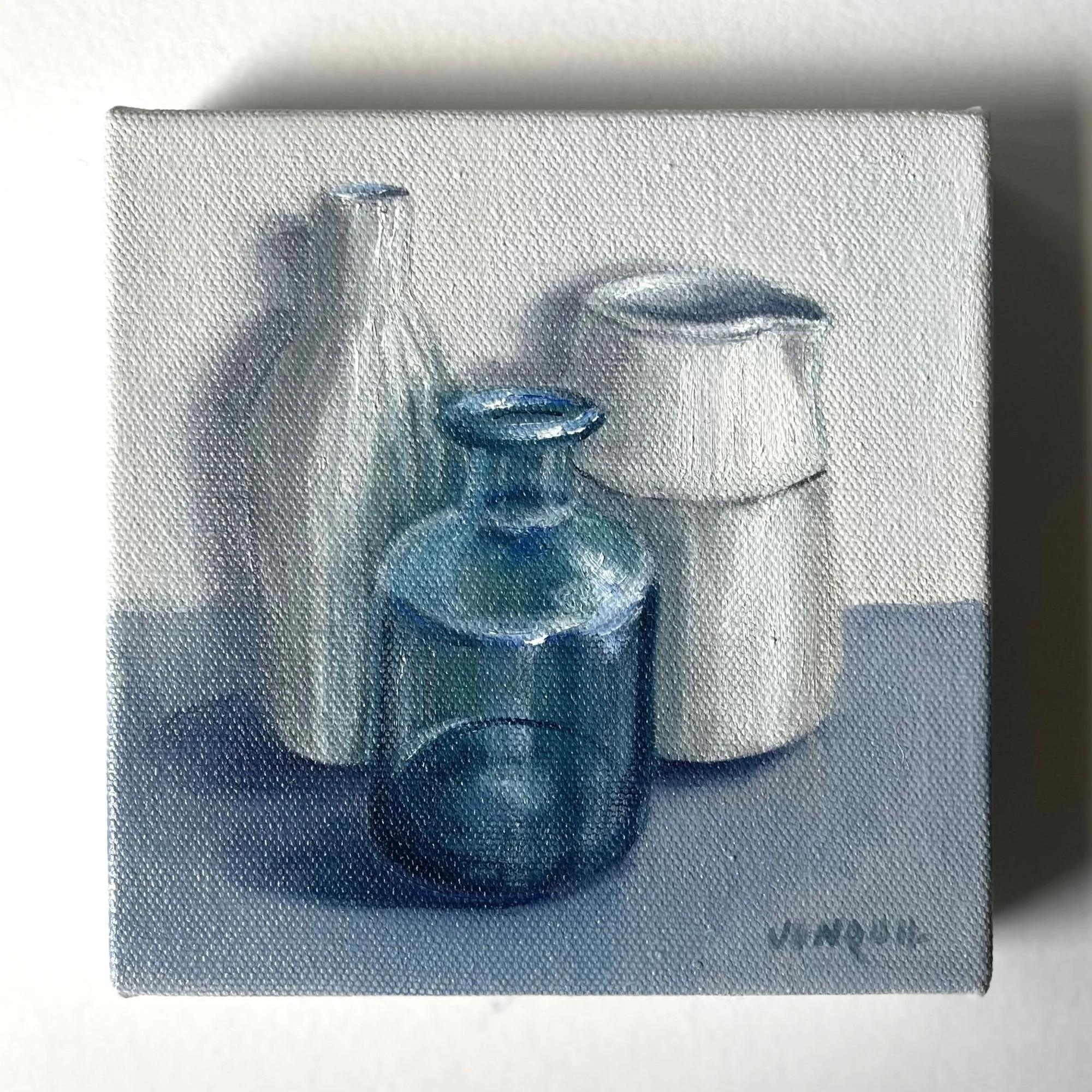 Small oil painting of blue glass bottle with white ceramic jug and vase on a grey surface.