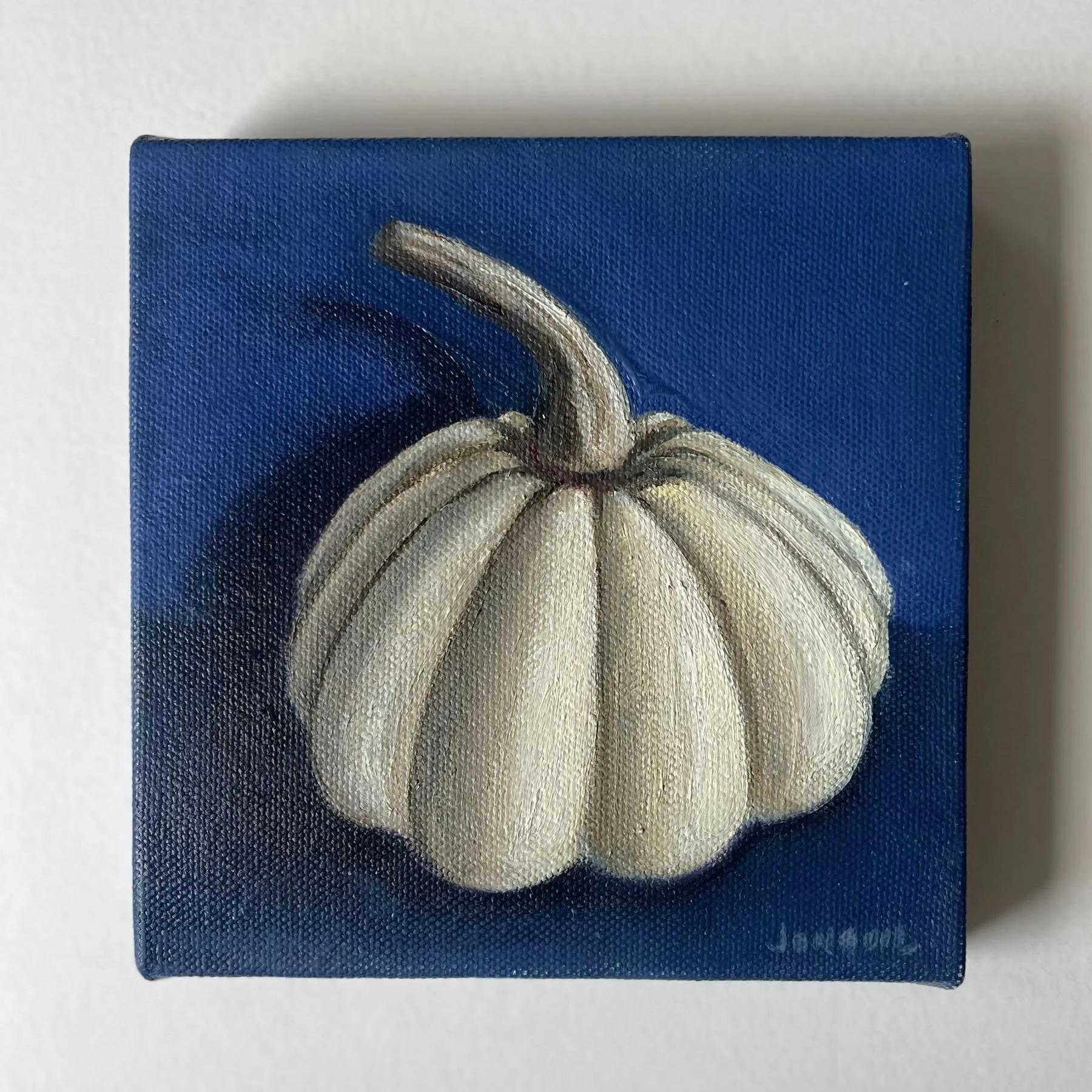 Mini oil painting of a white gourd on a deep blue background with soft shadow.