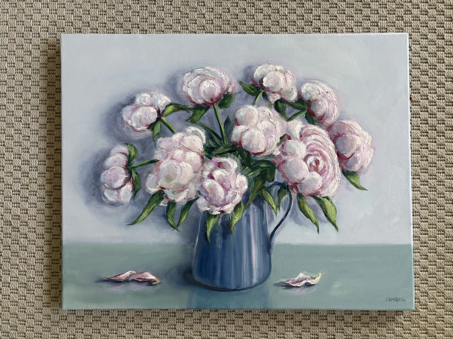 Original oil painting of pale pink peonies arranged in a blue ceramic vase on a soft green table against a light neutral background.JPG
