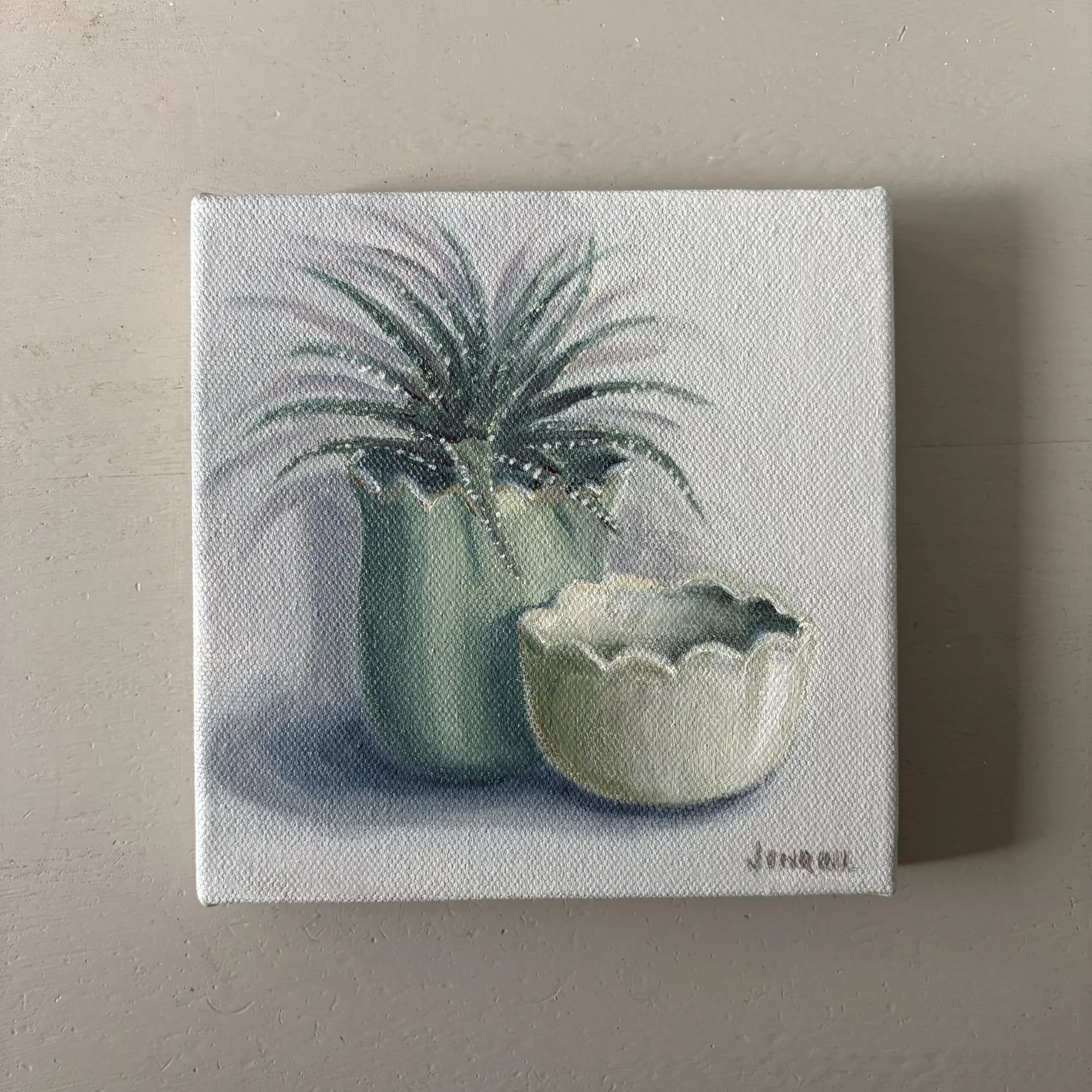 Small oil painting of a green potted plant beside a white scalloped bowl.