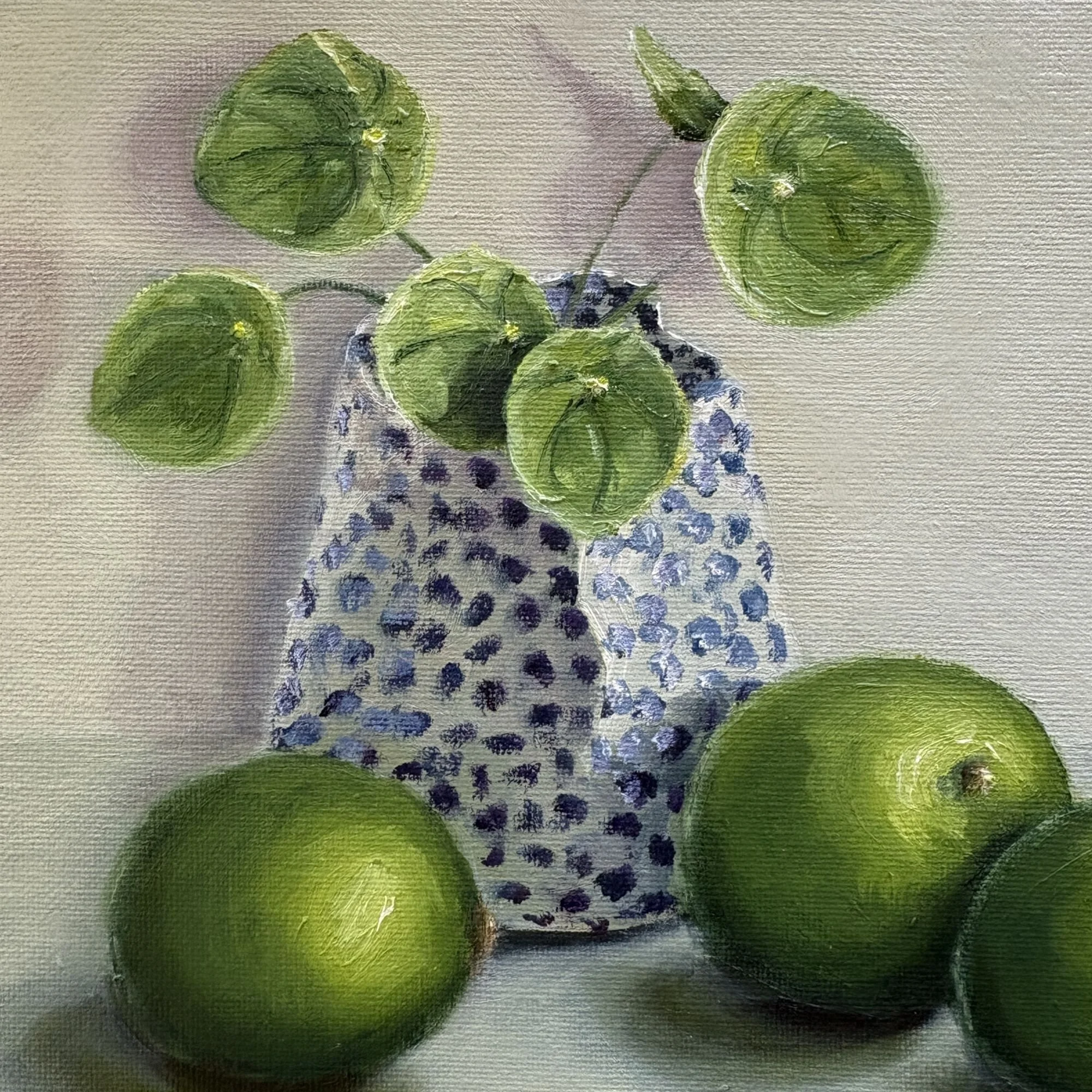 Close-up of original oil painting showing textured brushwork of limes and patterned vase