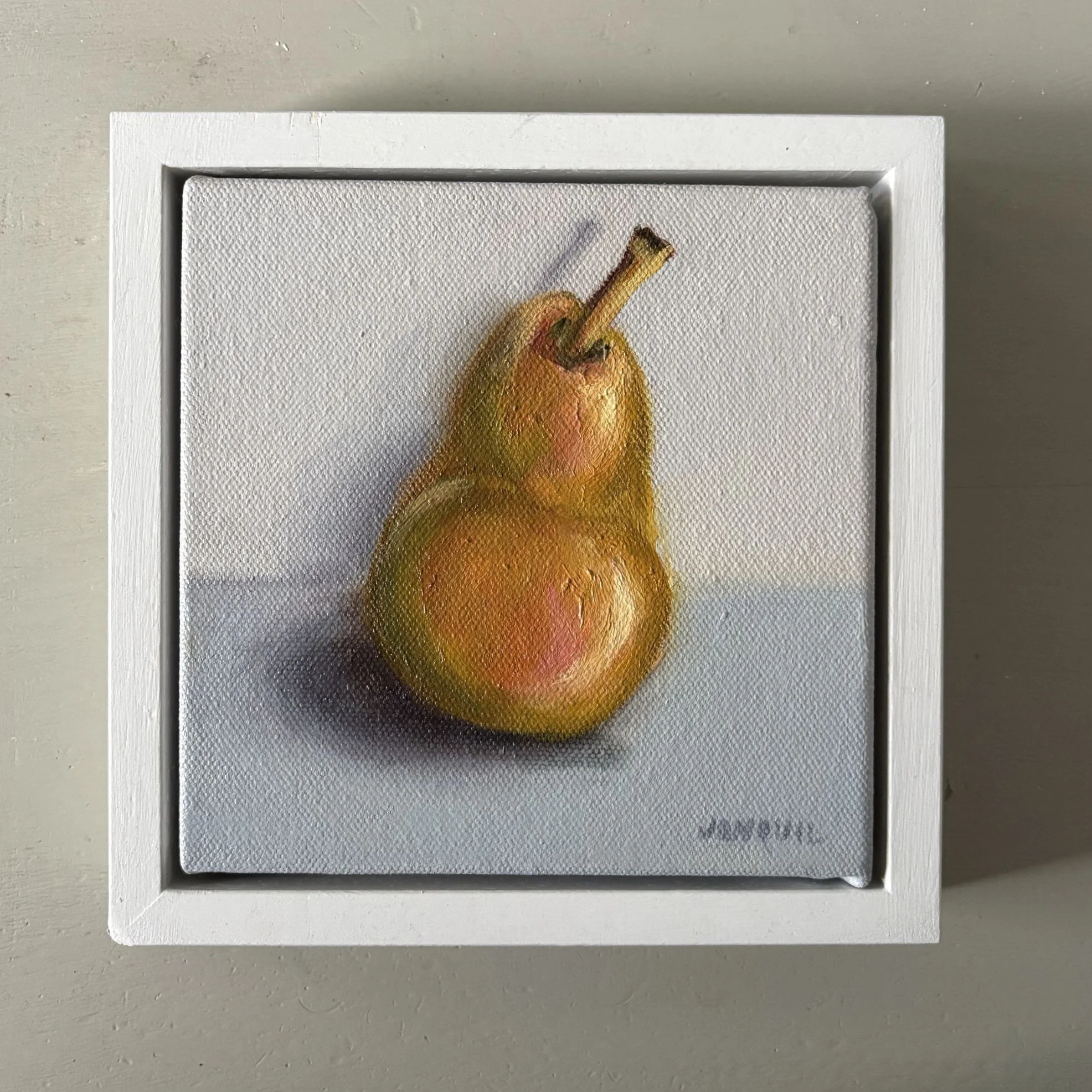 Small realistic oil painting of a golden pear on a pale grey background.