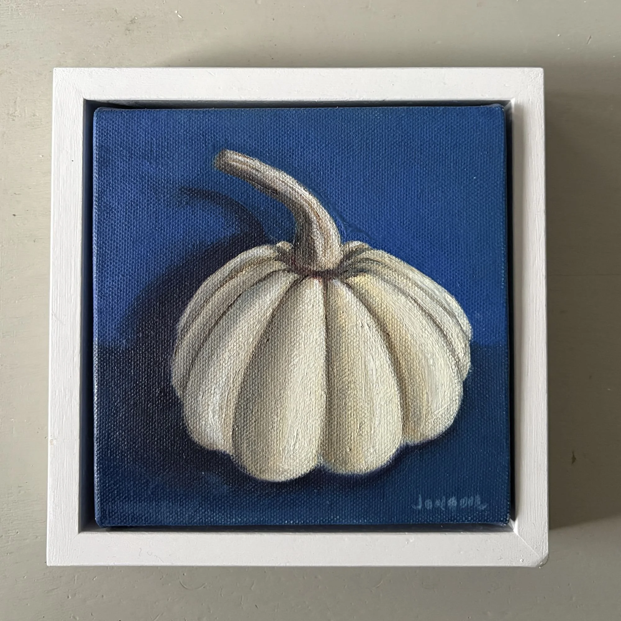 Mini oil painting of a white gourd on a deep blue background with soft shadow.