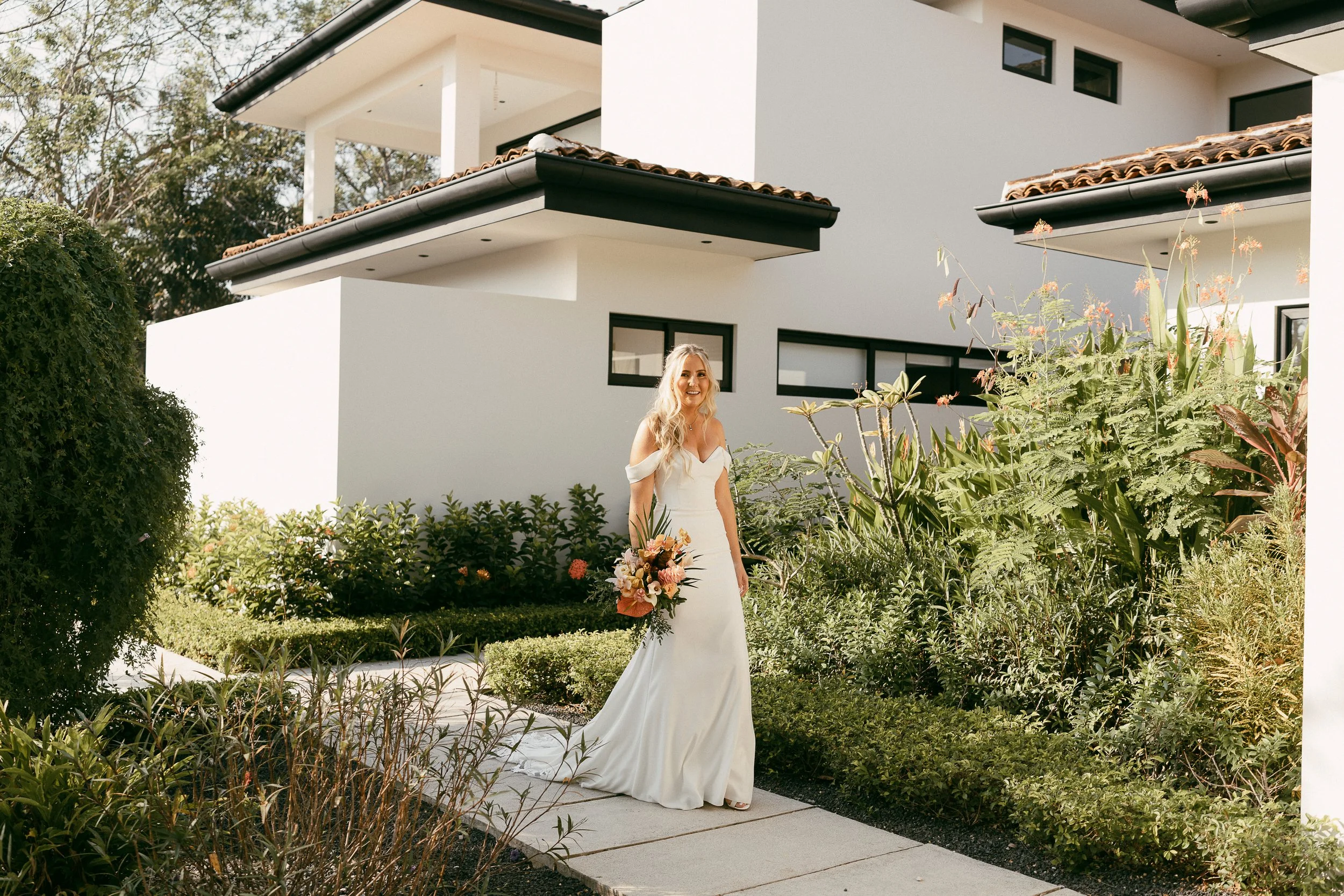 Tropical bridal bouquet with pastel blush, orange and terracotta flowers in Guanacaste, Costa Rica.