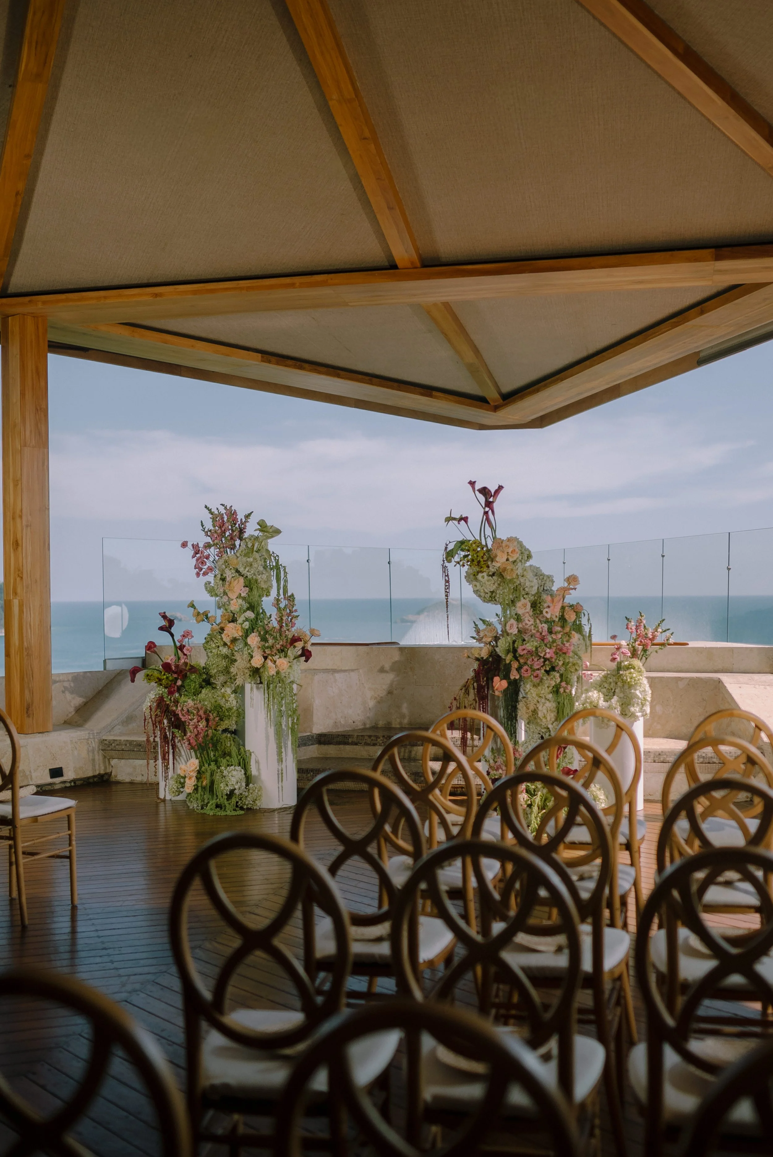 Modern ocean-view wedding ceremony with sculptural floral installations in Manuel Antonio, Costa Rica.