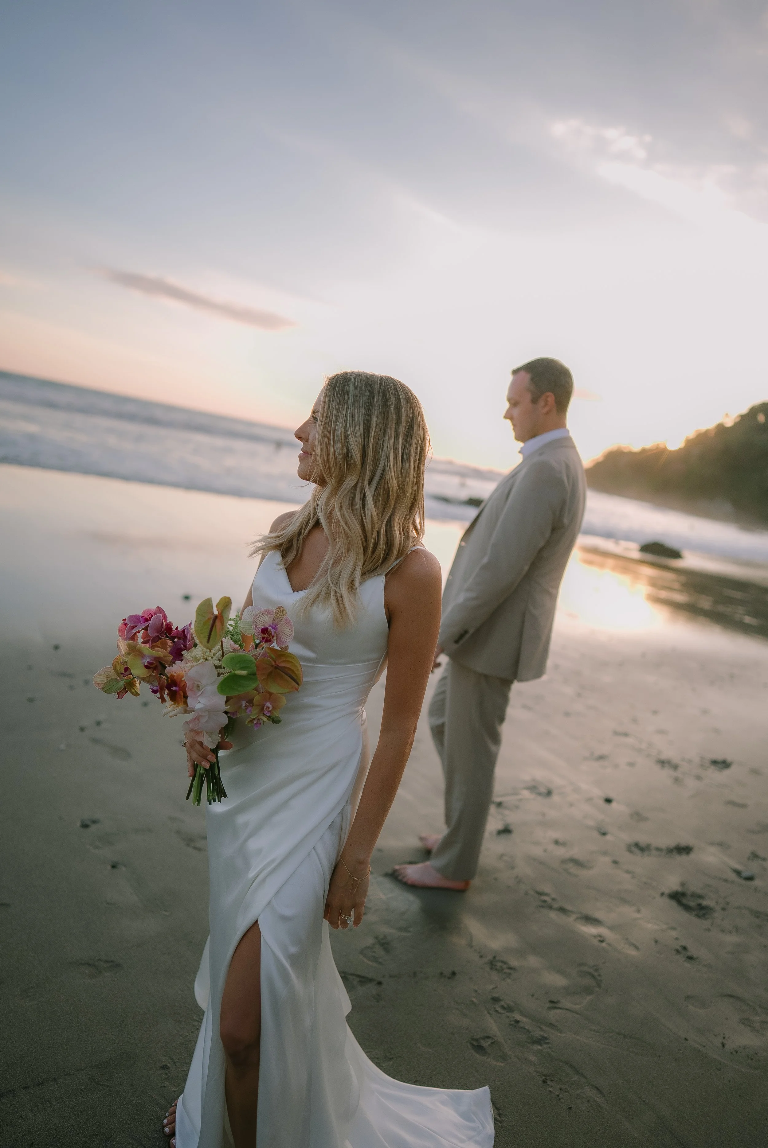 Contemporary wedding bouquet with blush, peach, burgundy and green floral accents.